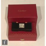 A Cased Cartier Travel Alarm Clock with Original Box and Leather Pouch. No 540488UM 2705 and