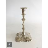 A late Victorian taper stick, canted square base with part fluted decoration below knop column and