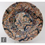A 19th Century Japanese Imari charger, of circular form, the deep well profusely decorated in iron-