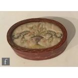 A 19th Century red Moroccan leather oval box with gilt tooled swag decoration, the cover with an
