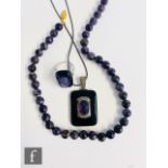 Three items of assorted amethyst set jewellery, a pendant with onyx border, a ring and a single