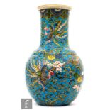 A 20th Century Chinese bottle vase, the turquoise ground inscribed with phoenix and long tailed