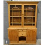 A Victorian and later pine dresser, the glazed double door upright section with a cornice pediment