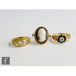 A 9ct gypsy set paste three stone ring with a 9ct cameo ring and a sapphire and diamond example,