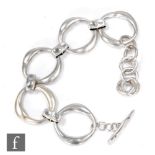 A hallmarked silver modern bracelet comprising five circular open links one set with two sunk set