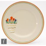 A Clarice Cliff 10in plate decorated in the Riverside Crocus pattern with a spray of flowers above