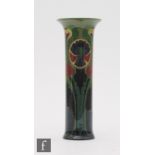 An early 20th Century Gouda cylinder vase with a slight flared neck decorated with a portrait of