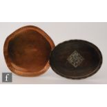 An Arts and Crafts planished copper tray of oval form with applied pewter foliate detail by Hugh