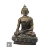 A 19th/20th Century cast bronze figure of Shakyamuni Buddha, modelled seated With eyes downcast in