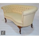 An early 20th Century kidney-shaped two seat sofa or settee, upholstered in diamond patterned button