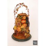A late Victorian wax study of fruit on an ebonised base beneath a glass dome, A/F.
