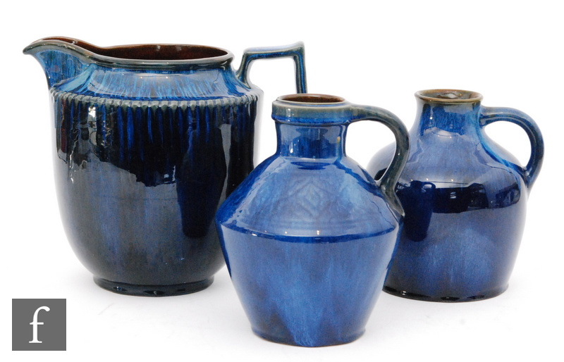 A large Bourne Denby Danesby Ware jug decorated in an all over electric blue dribble glaze,