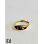 An 18ct hallmarked sapphire and diamond seven stone boat shaped ring three sapphires spaced by