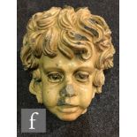 A glazed stoneware cherub's head or plaque, un-marked, height 36cm and width 30cm, S/D.