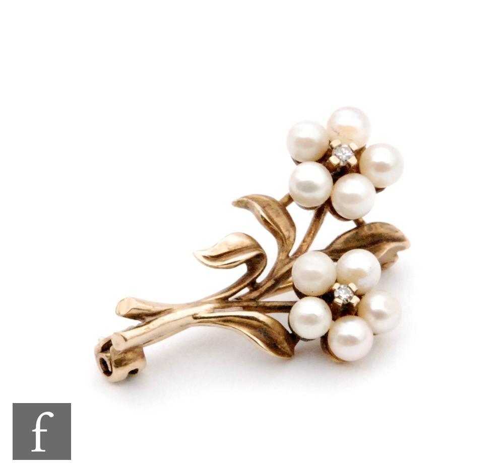 A 9ct hallmarked floral spray brooch modelled as two cultured pearl flower heads each with single