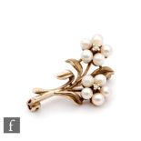 A 9ct hallmarked floral spray brooch modelled as two cultured pearl flower heads each with single