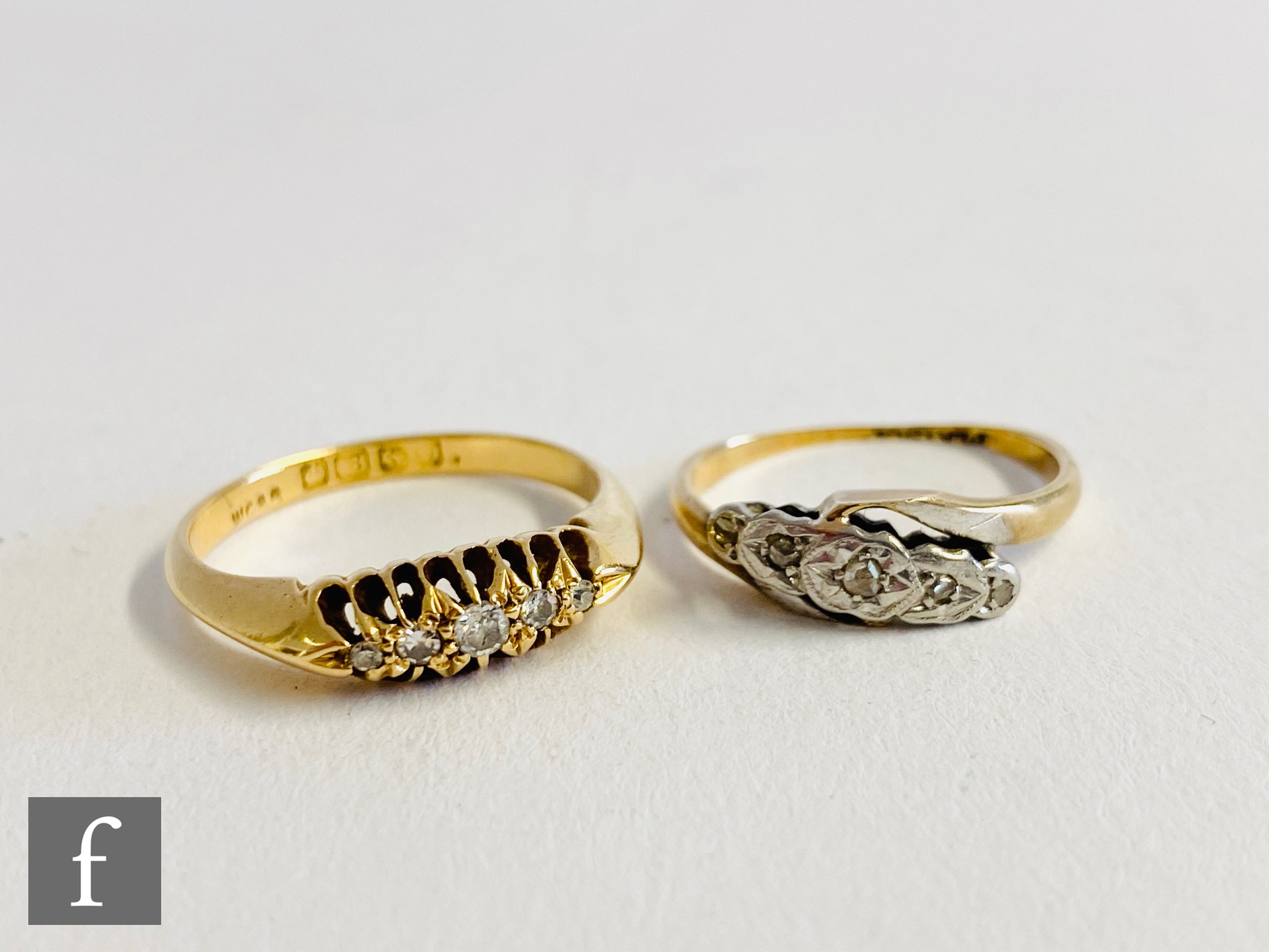 An early 20th Century 18ct diamond five stone boat shaped ring, with a 9ct example set of a twist,