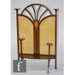 An Art Nouveau mahogany firescreen, with inlaid paterae, satin lined panels and square platform