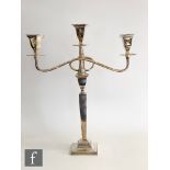 A hallmarked silver three light candelabra, square base below plain flaring column, scroll arms