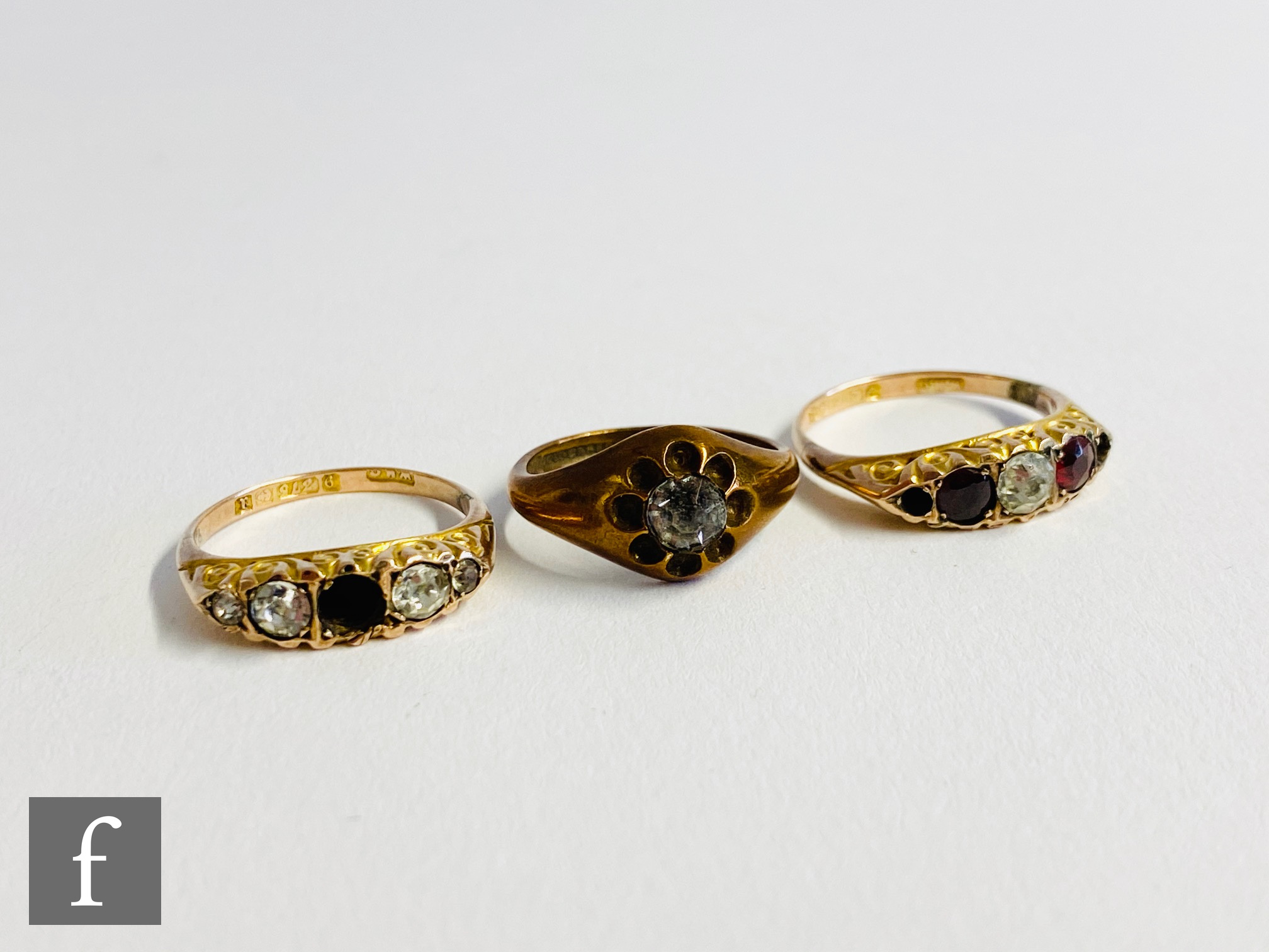 Two early 20th Century stones set five stone rings, each with missing stones, total weight 2.7g with