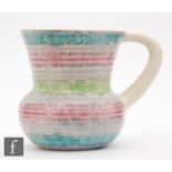 A Clarice Cliff shape 635 flower jug decorated in the Aura pattern with green, grey and pink