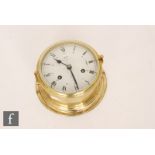 A late 20th Century German Schatz ‘Royal Mariner’ brass bulk head clock, with circular white painted