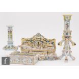 A late 19th Century French Faience desk stand with two letter racks, two inkwells and a front