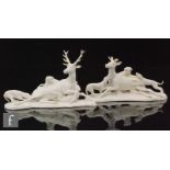 A pair of 19th Century Nymphenburg blanc de chine models of stags, each with a seated beast being