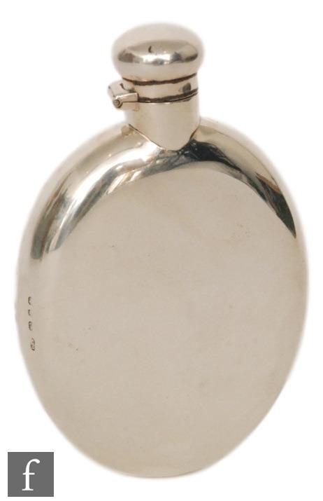 A late 19th Century hallmarked silver oval hip flask of plain form, terminating in bayonet cap,