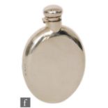 A late 19th Century hallmarked silver oval hip flask of plain form, terminating in bayonet cap,