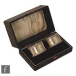 A cased pair of hallmarked silver napkin rings of plain form with gadroon borders, Birmingham