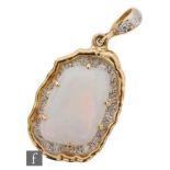 An 18ct hallmarked opal and diamond pendant, irregular claw set opal above a pave diamond set ground
