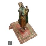 A late 19th Century Bergmann style cold painted bronze model of an Arabian carpet seller,
