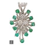 A modern 18ct white gold emerald and diamond pendant, four central brilliant cut diamonds each