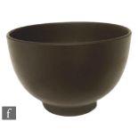 A small Wedgwood black basalt bowl of footed circular form, in the manner of Keith Murray, impressed