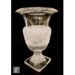 A large 20th Century clear crystal glass vase in the manner of Baccarat of pedestal urn form on a
