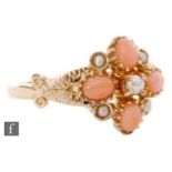 A 9ct hallmarked Edwardian style coral and seed pearl ring, four coral spaced by seed pearls,