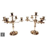 A pair of Mexican Sterling silver five light candelabra, circular scalloped edged bases below