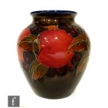 A William Moorcroft vase of ovoid form with roll rim, tube line decorated in the Pomegranate pattern