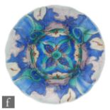 A Clarice Cliff circular dish form wave edge plate circa 1930/31 hand decorated in the Inspiration