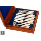 A matched set of twelve Victorian hallmarked silver and mother of pearl knives and forks,