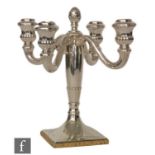 A German silver four light candelabra, square base below flaring column and central pineapple