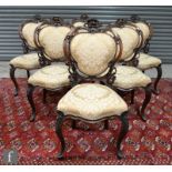 A set of six Victorian walnut dining chairs, the pierced backs carved in deep relief with floral and
