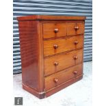 A Victorian mahogany veneered chest of two short over three long drawers, raised to a plinth base,