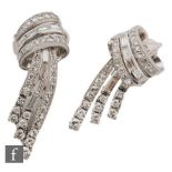 A pair of 18ct white gold diamond drop clip on earrings each with a baguette and brilliant cut