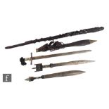 Two North African short swords one with pewter mounted handle and ribbed decoration, an Eastern