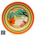 A Clarice Cliff circular plate circa 1931, hand painted in the Red Roofs pattern with a stylised