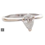 An 18ct hallmarked white gold diamond solitaire ring, pear shaped claw set diamond, weight