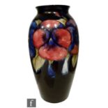 A large 1930s William Moorcroft vase of slender shouldered ovoid form with flared rim, tubeline