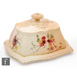 An early 20th Century Royal Worcester blush ivory butter dish and cover decorated with floral sprays